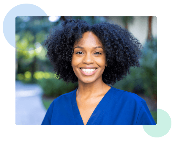 Nurse smiling wearing blue scrubs